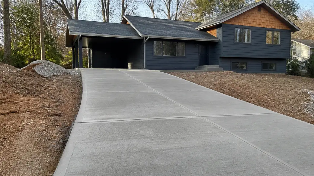 concrete installation completed by a local contractor at a grey split-level home in Sandy Springs, GA, in open shade.