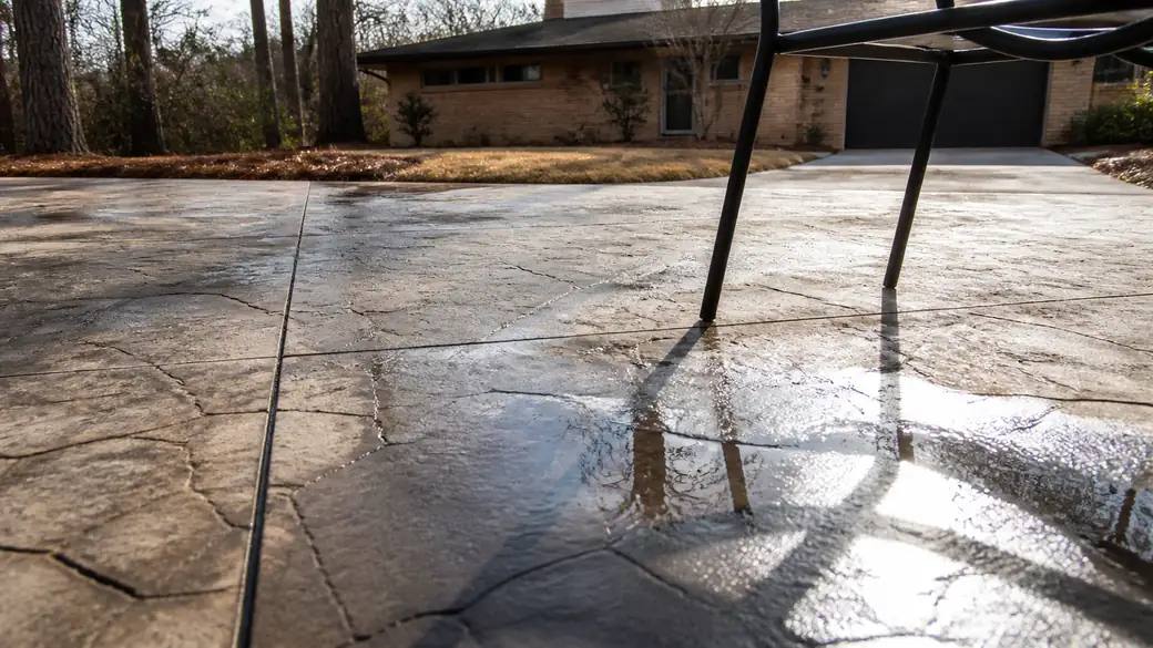concrete patio repair completed by a local contractor at a buff-brick ranch home in Sandy Springs, GA, after a rain shower.